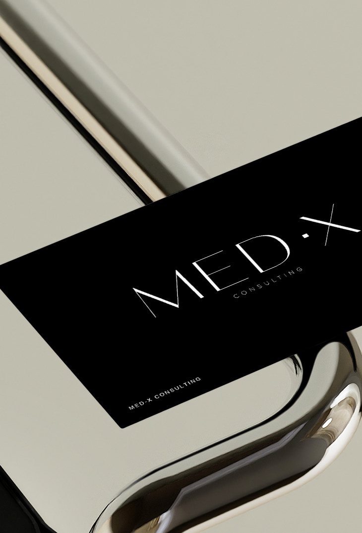 MED·X Consulting card on a reflective chrome surface
